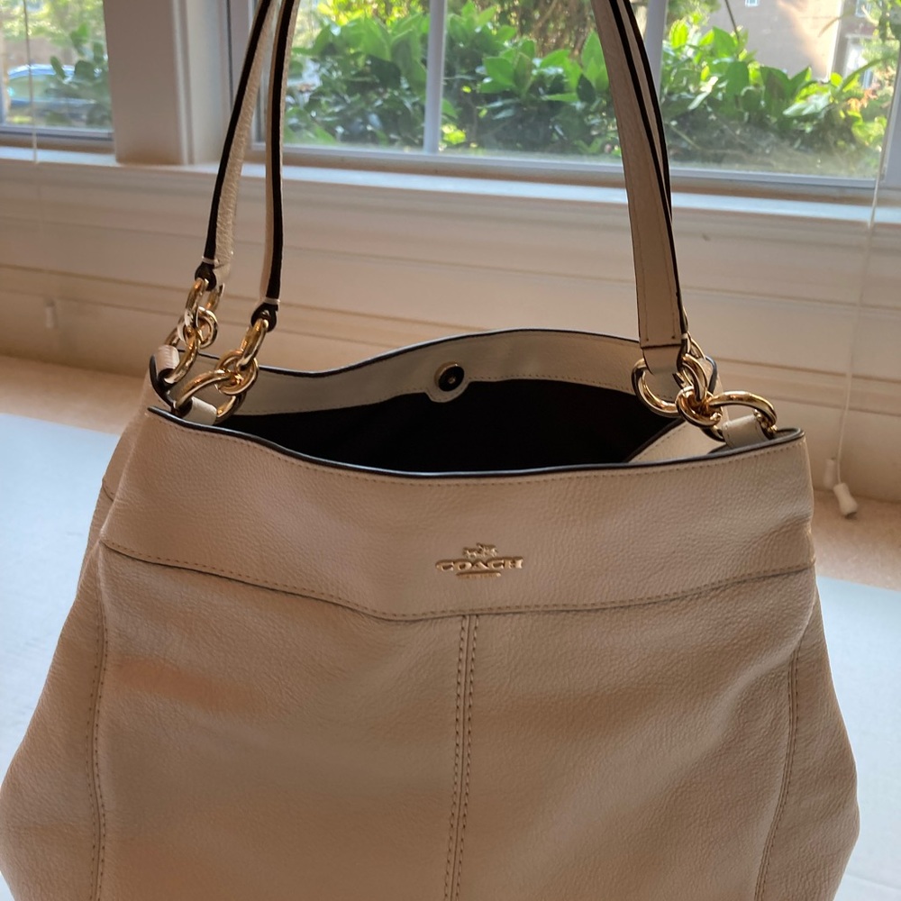 Women’s Coach handbag with free matching wallet.
